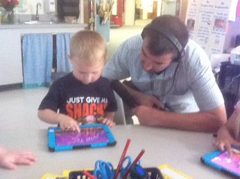 Kindergarten student being interviewed for the radio